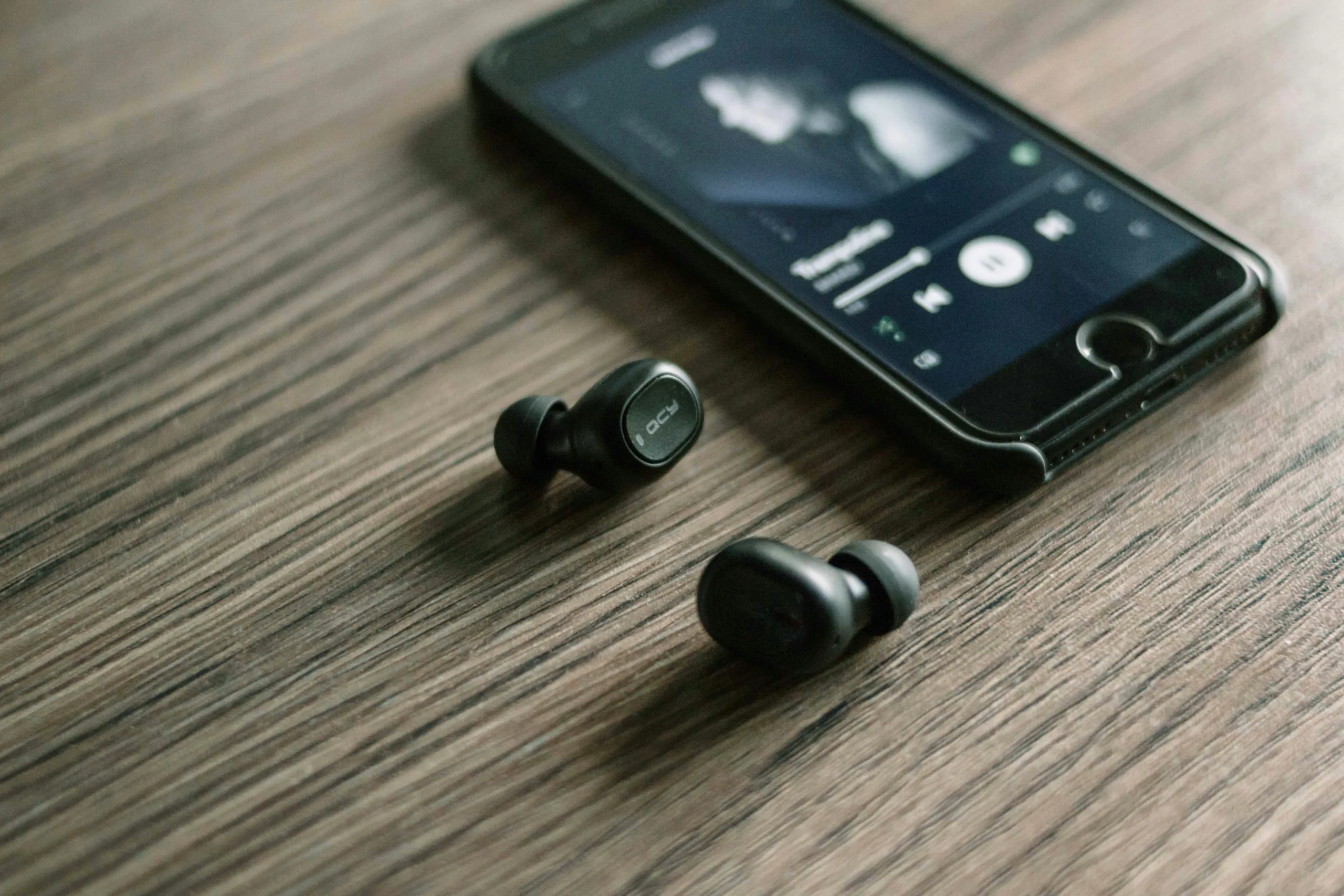 Close-up view of tiny rice-grain camera sensor embedded inside wireless earbuds
